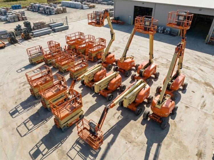Luchtfoto van bouwplaats met verschillende hoogwerkers: schaarliften, knikarmliften van 6 tot 20+ meter hoog in oranje en geel